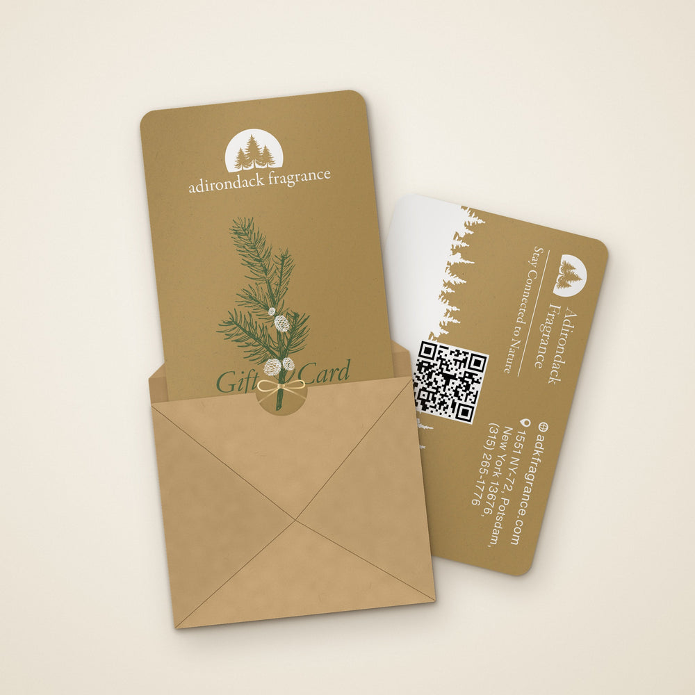 Adirondack Fragrance physical gift card in a kraft envelope, with the back of the card beside it
