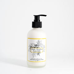 Bottle of Maple Bourbon Body Milk with a label on a white background