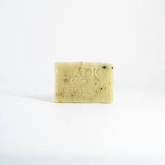 Bar of soap with 'ADK Handmade Cedar Soap' text on a white background