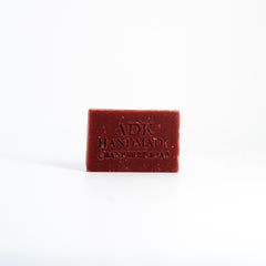 Red bar of soap with 'ADK Handmade' branding on a white background