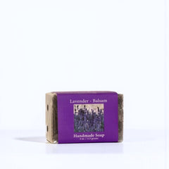 Handmade lavender soap bar with a purple label on a white background