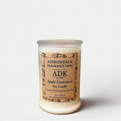 Candle with 'ADK' label on a white background
