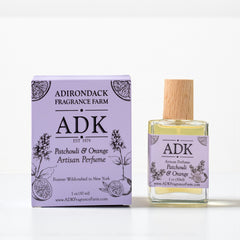 ADK patchouli and orange artisan perfume bottle and packaging on a white background