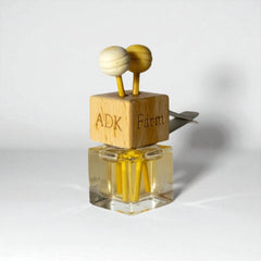 Small glass bottle with wooden cap on a white background
