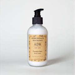 White lotion bottle with a black pump and 'ADK' label on a white background