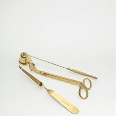 Set of gold surgical tools on a white background
