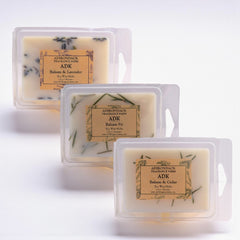 Three Adirondack Fragrance Farm wax melts on a white background