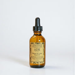 Bottle of Adirondack Fragrance Farm beard oil on a white background