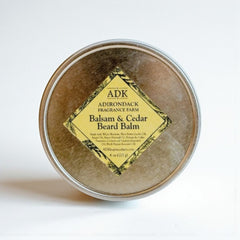 Balsam & Cedar Beard Balm container with ADK label on a white background
