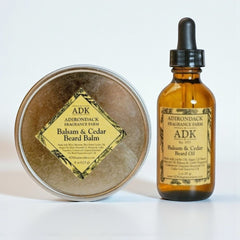 Adirondack Fragrance Farm balm and beard oil on a white background